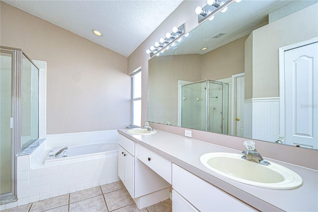 bathroom featuring lofted ceiling, tile patterned floors, separate shower and tub, a textured ceiling, and vanity