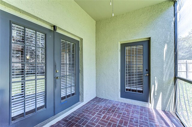 view of exterior entry featuring french doors