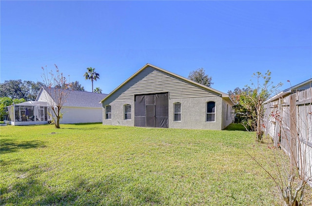 rear view of house featuring a yard