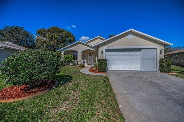 single story home with an attached garage, covered porch, concrete driveway, stucco siding, and a front yard