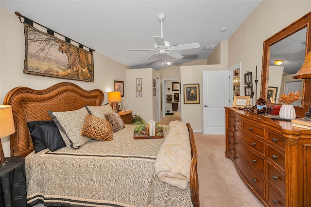 bedroom featuring lofted ceiling, a ceiling fan, visible vents, and light colored carpet