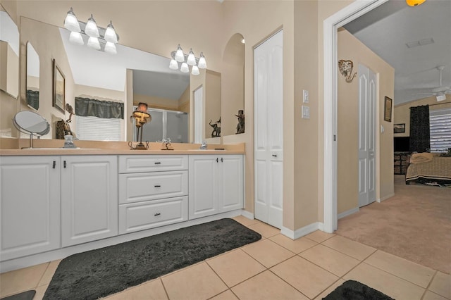 bathroom featuring tile patterned flooring, a sink, and a shower stall