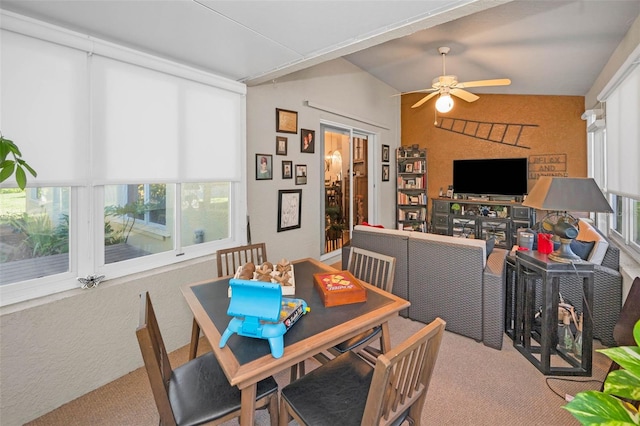 carpeted dining area with lofted ceiling and ceiling fan