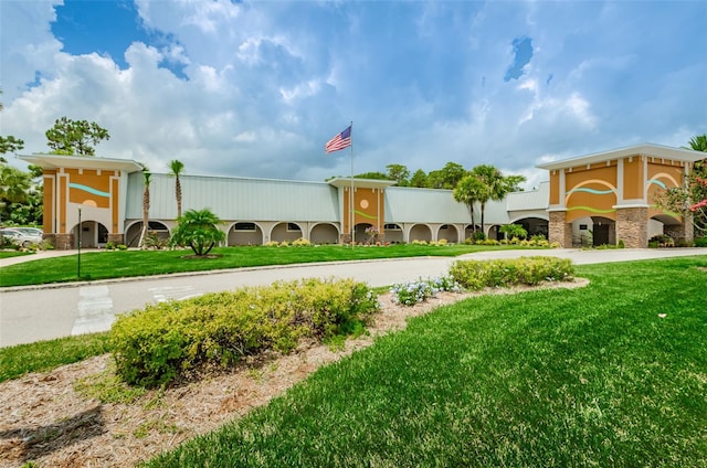 view of home's community with concrete driveway and a yard