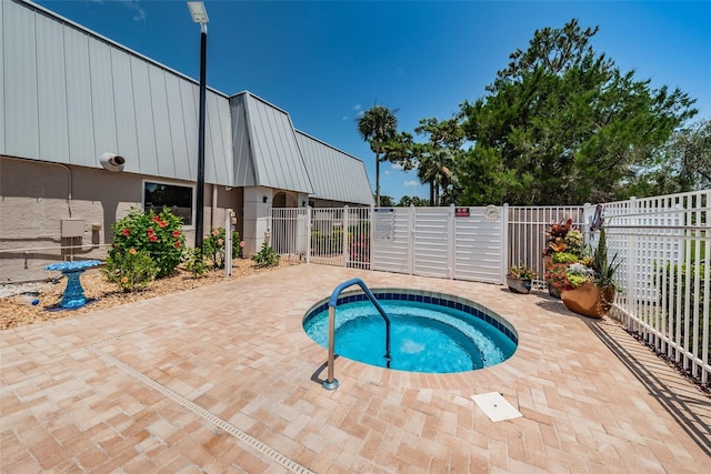 view of swimming pool with a patio, fence private yard, and a gate