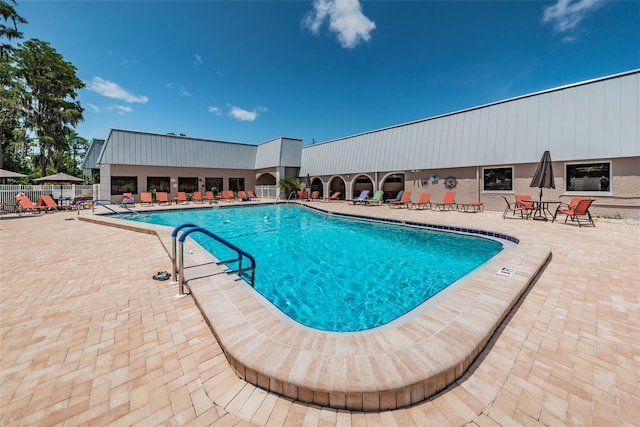 pool featuring a patio area and fence