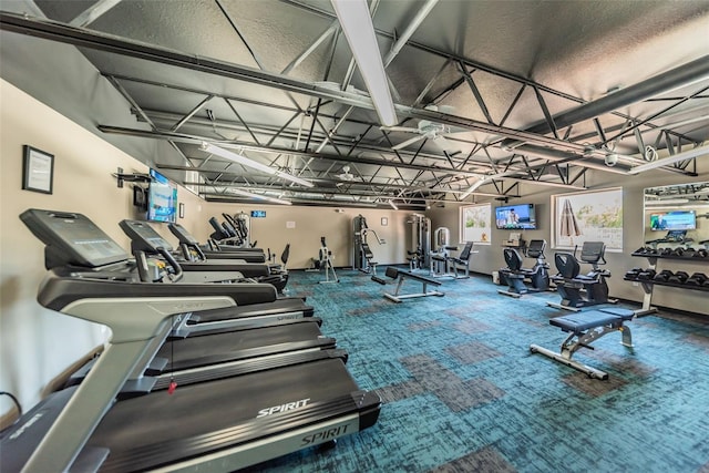 exercise room featuring a garage and carpet flooring