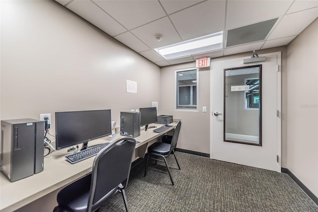 carpeted home office with a drop ceiling and baseboards