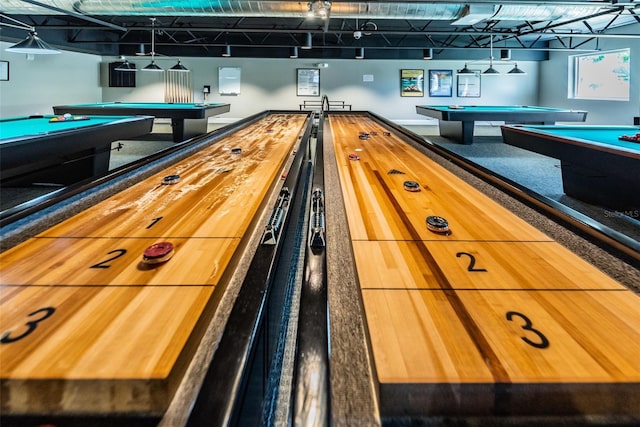 recreation room with pool table and rail lighting