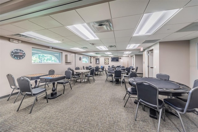 dining area with carpet, visible vents, and a paneled ceiling