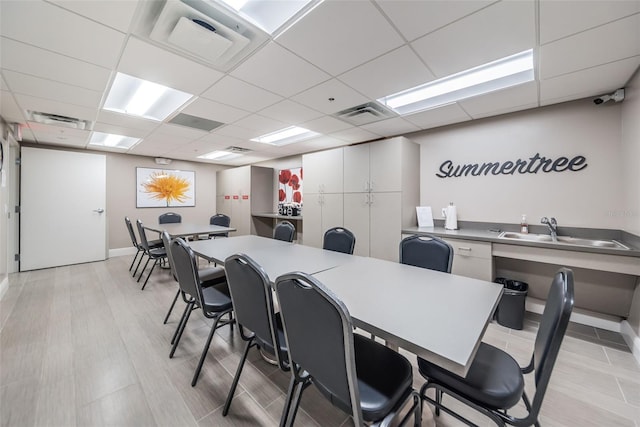 interior space featuring a paneled ceiling and visible vents