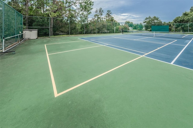 view of tennis court featuring fence