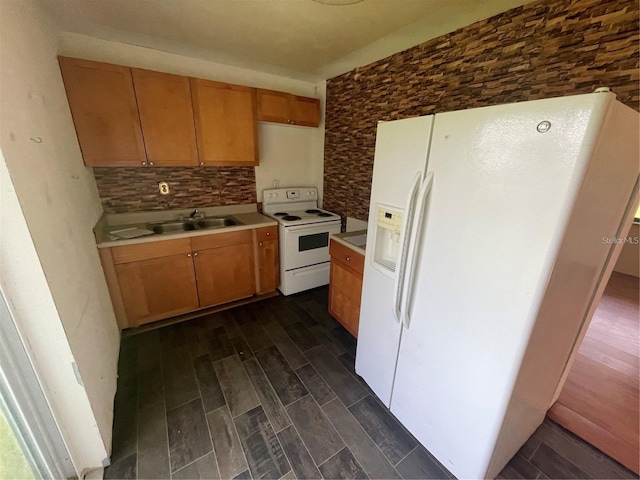 kitchen featuring tasteful backsplash, white appliances, and sink