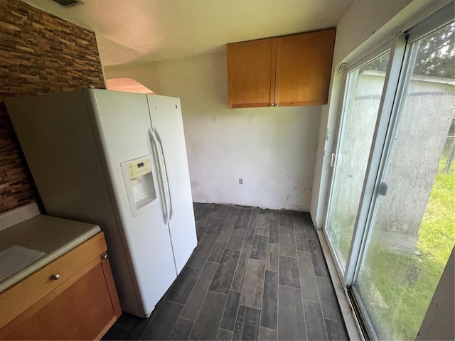 kitchen with white refrigerator with ice dispenser