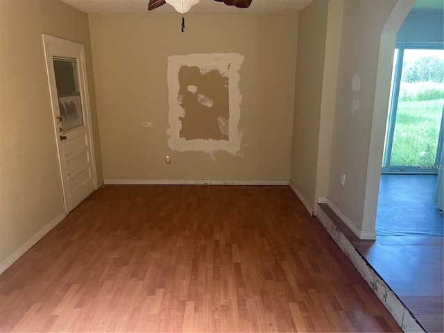 unfurnished room with wood-type flooring and ceiling fan