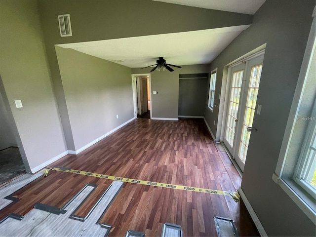 empty room featuring french doors, ceiling fan, lofted ceiling, and hardwood / wood-style floors