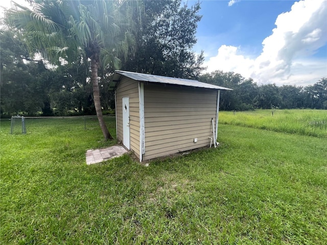 view of outbuilding with a lawn