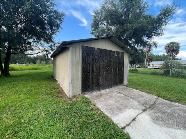 view of outbuilding featuring a yard