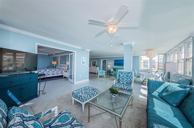 living area featuring baseboards, ornamental molding, visible vents, and a ceiling fan