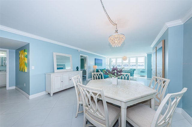 dining space with an inviting chandelier, baseboards, light tile patterned floors, and ornamental molding