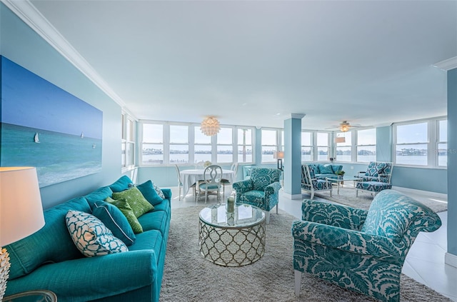 living area featuring ornamental molding, tile patterned flooring, and plenty of natural light