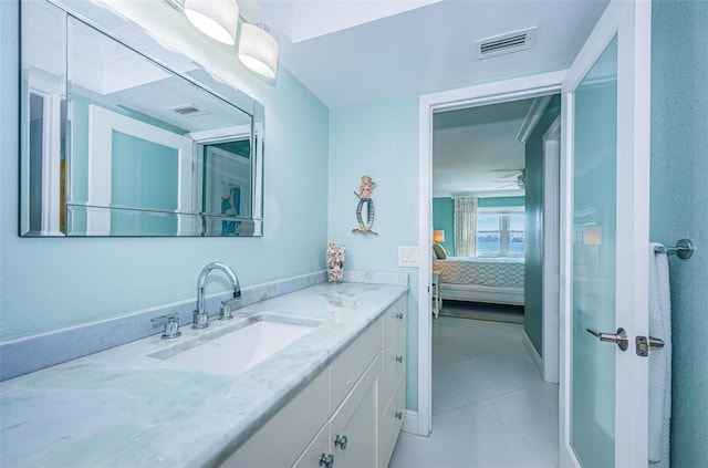 ensuite bathroom with ensuite bathroom, vanity, tile patterned flooring, and visible vents