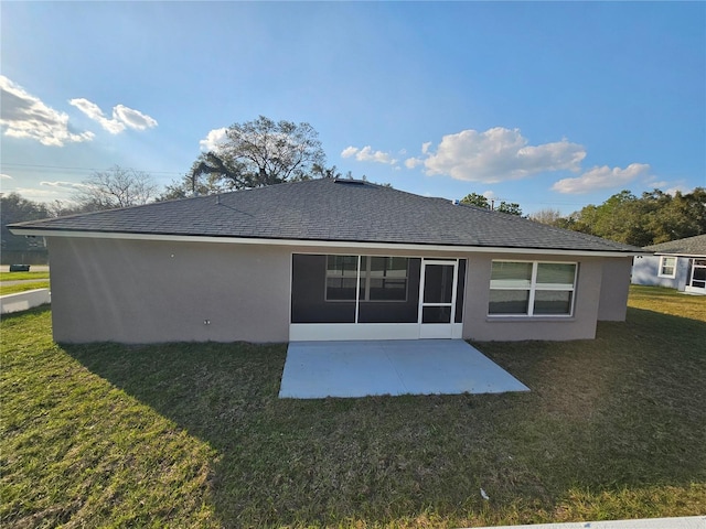 rear view of house with a patio and a lawn