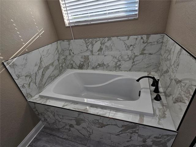 bathroom featuring tiled bath