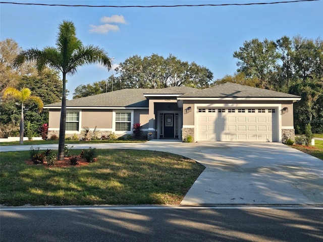 view of front of house with a garage and a front lawn