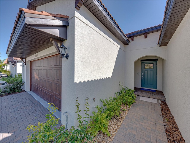 doorway to property featuring a garage