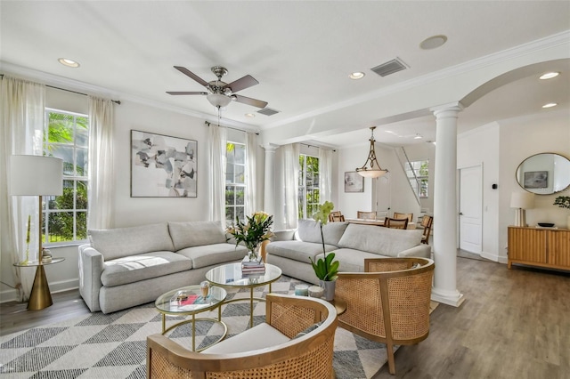 living room with crown molding, decorative columns, ceiling fan, and hardwood / wood-style flooring