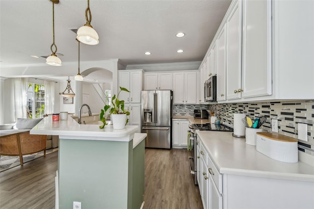 kitchen featuring stainless steel appliances, a kitchen island with sink, sink, and white cabinets