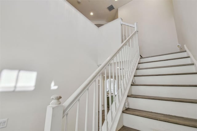 staircase featuring a high ceiling