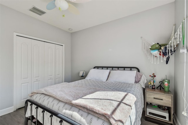 bedroom featuring hardwood / wood-style flooring, a closet, and ceiling fan