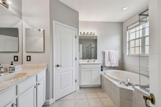 bathroom featuring plus walk in shower, tile patterned floors, and vanity