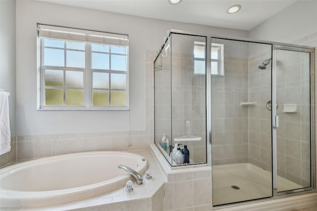 bathroom featuring independent shower and bath