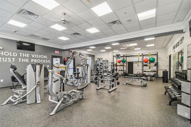 gym with a paneled ceiling and ornamental molding