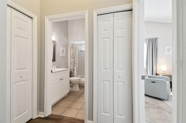 full bathroom with vanity, toilet, tile patterned flooring, and shower / bath combo with shower curtain