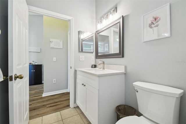 bathroom featuring vanity, tile patterned flooring, and toilet