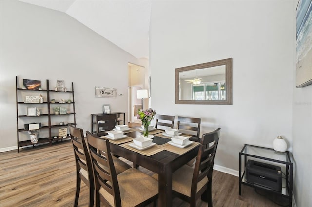 dining room featuring hardwood / wood-style floors and high vaulted ceiling