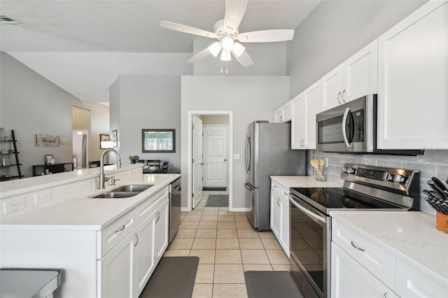 kitchen featuring white cabinetry, appliances with stainless steel finishes, sink, and light tile patterned floors