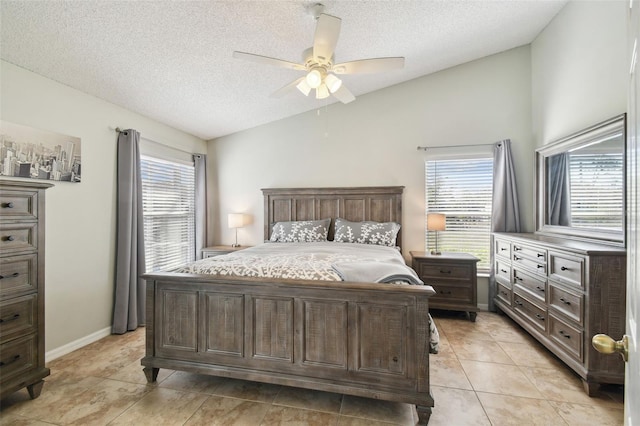 bedroom featuring multiple windows, light tile patterned flooring, lofted ceiling, and a textured ceiling