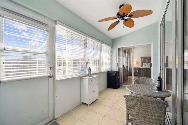 sunroom featuring ceiling fan and lofted ceiling