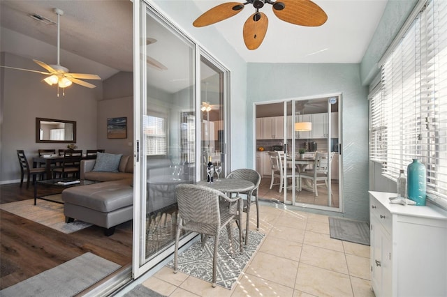 sunroom featuring ceiling fan and lofted ceiling