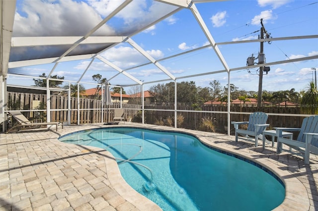 view of swimming pool with a patio and a lanai