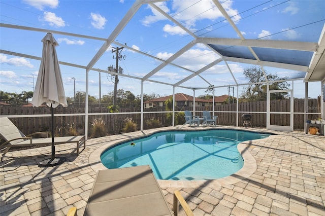 view of pool with a lanai and a patio area