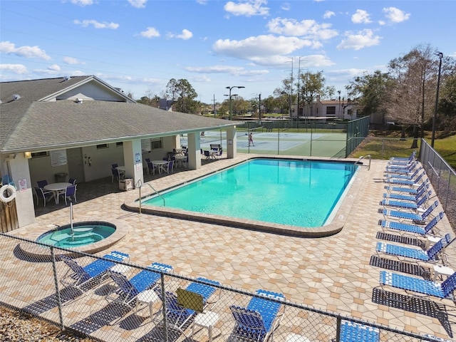 view of pool featuring a patio, tennis court, and a community hot tub