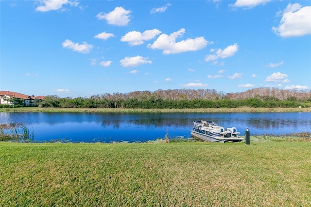 view of dock featuring a water view and a yard