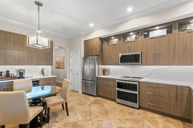 kitchen featuring crown molding, decorative backsplash, stainless steel appliances, and hanging light fixtures