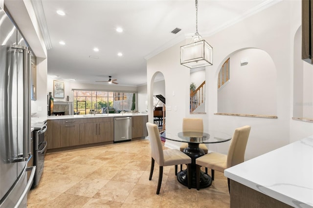 dining space featuring ceiling fan and ornamental molding